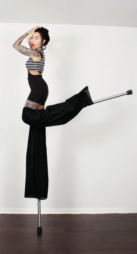 Stilts Performer Kicking